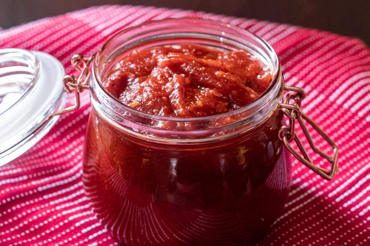 thai style tomato chili jam stored in a glass jar