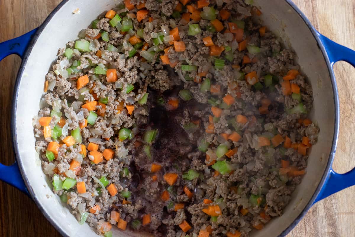 red wine is added to the dutch oven