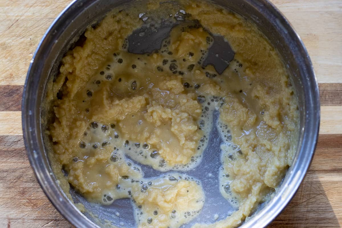Flour and melted butter are mixed in a pan for making bechamel sauce.