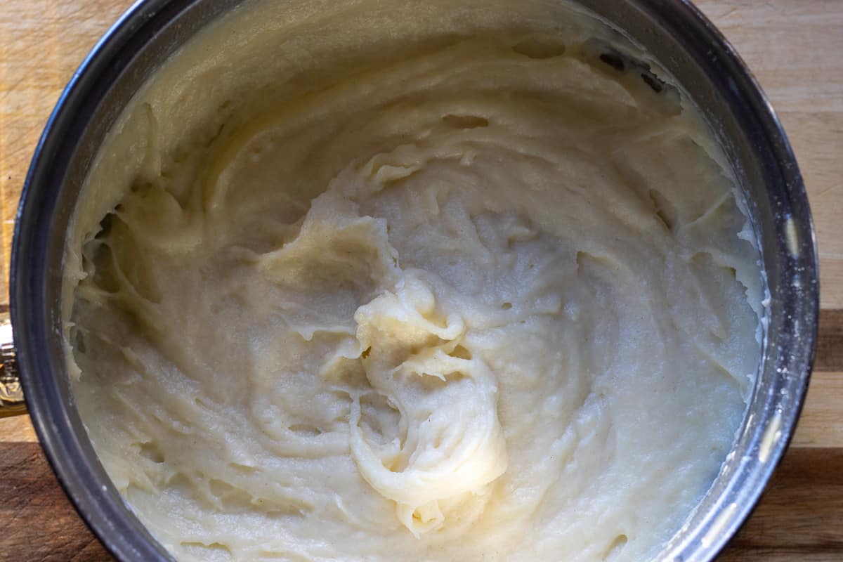 Adding a little bit of milk to the flour mixture.