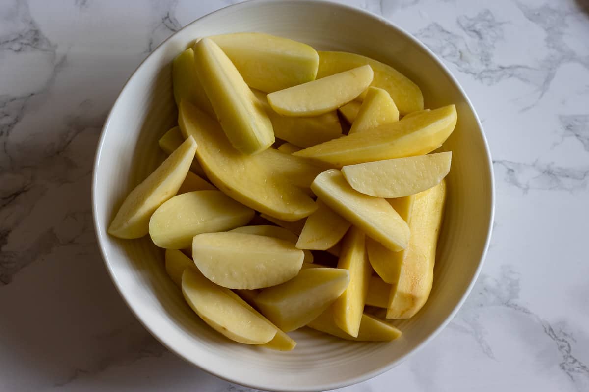 potatoes are cut in wedges