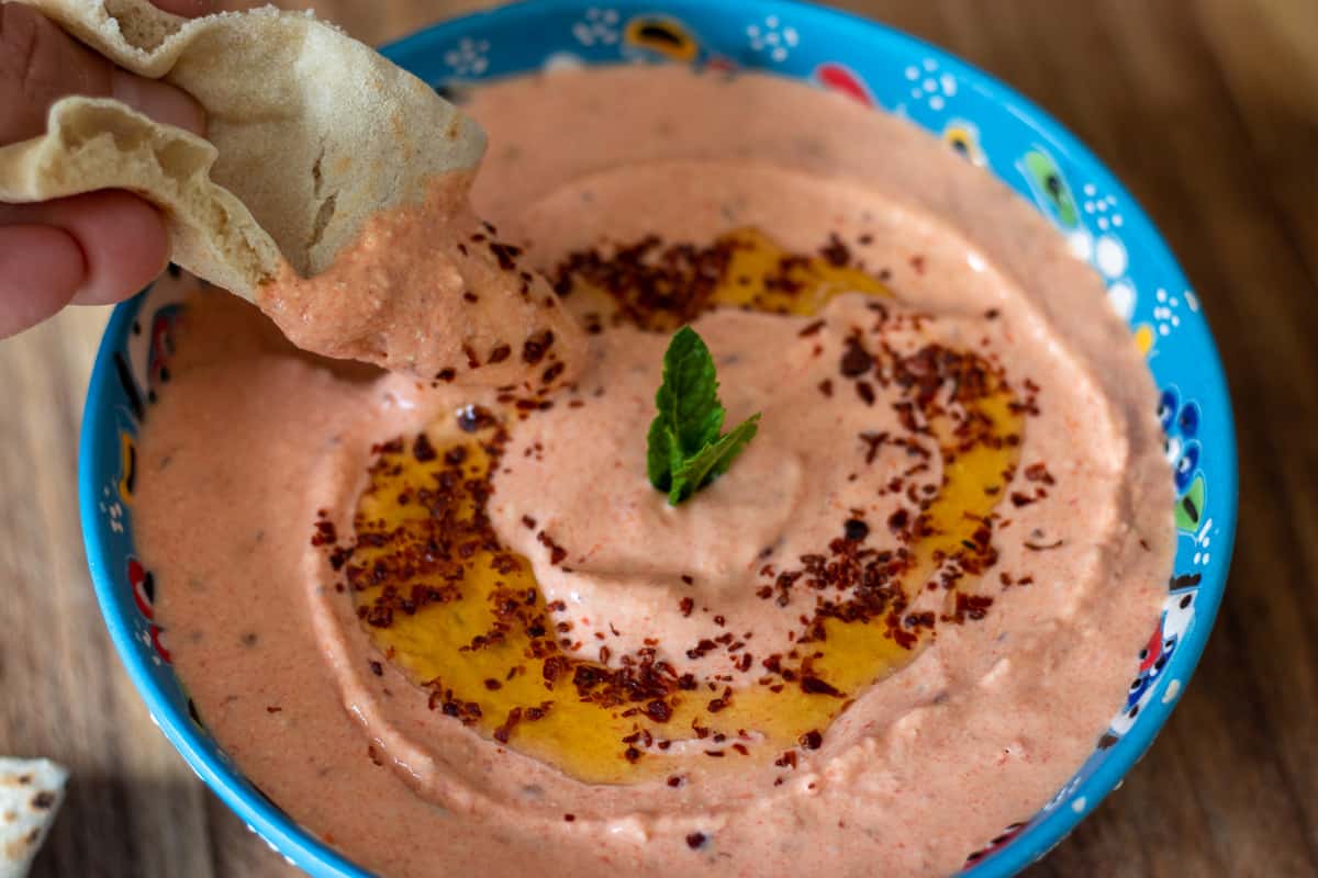 A piece of pita bread dipped in Tirokafteri