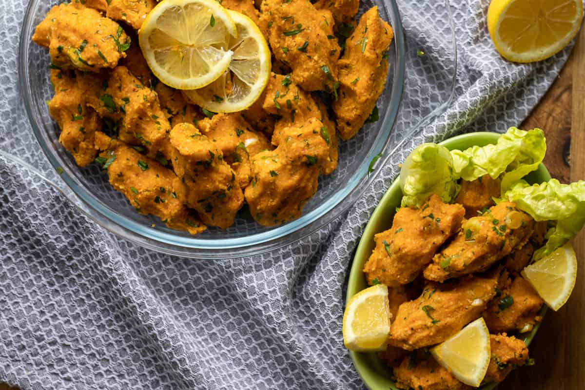 serving mercimek Koftesi with lettuce leaves and sliced lemons
