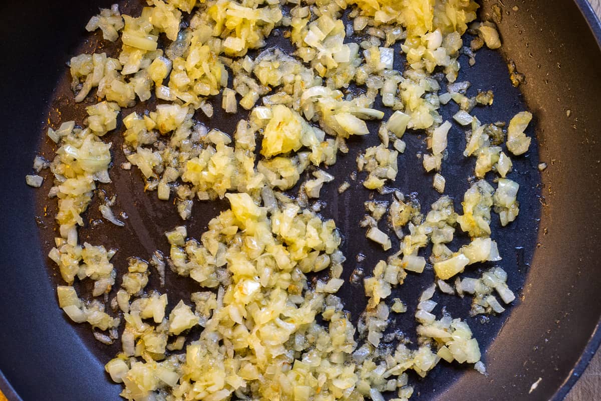 onions are sautéed in a pan with olive oil