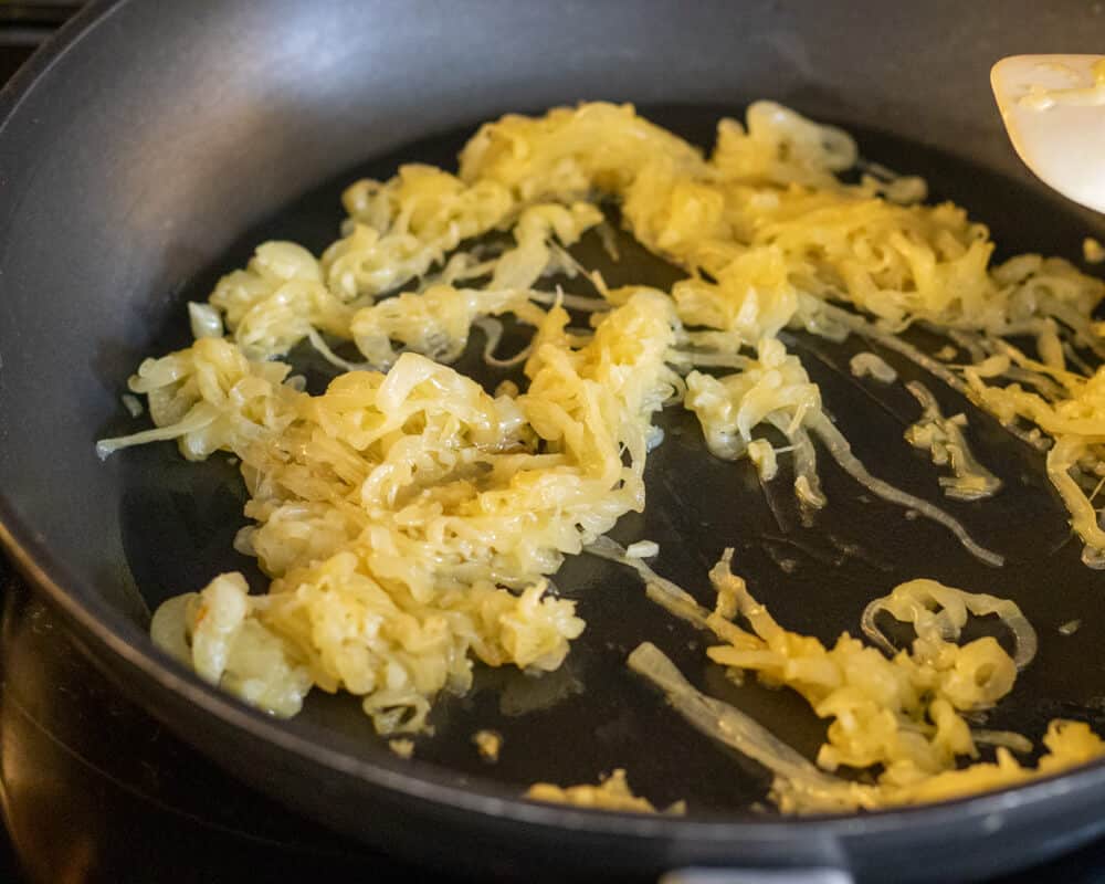 onions are sautéed in a pan