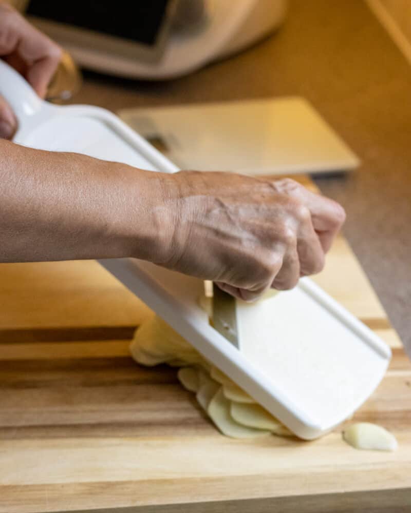slice the potatoes using a mandolin