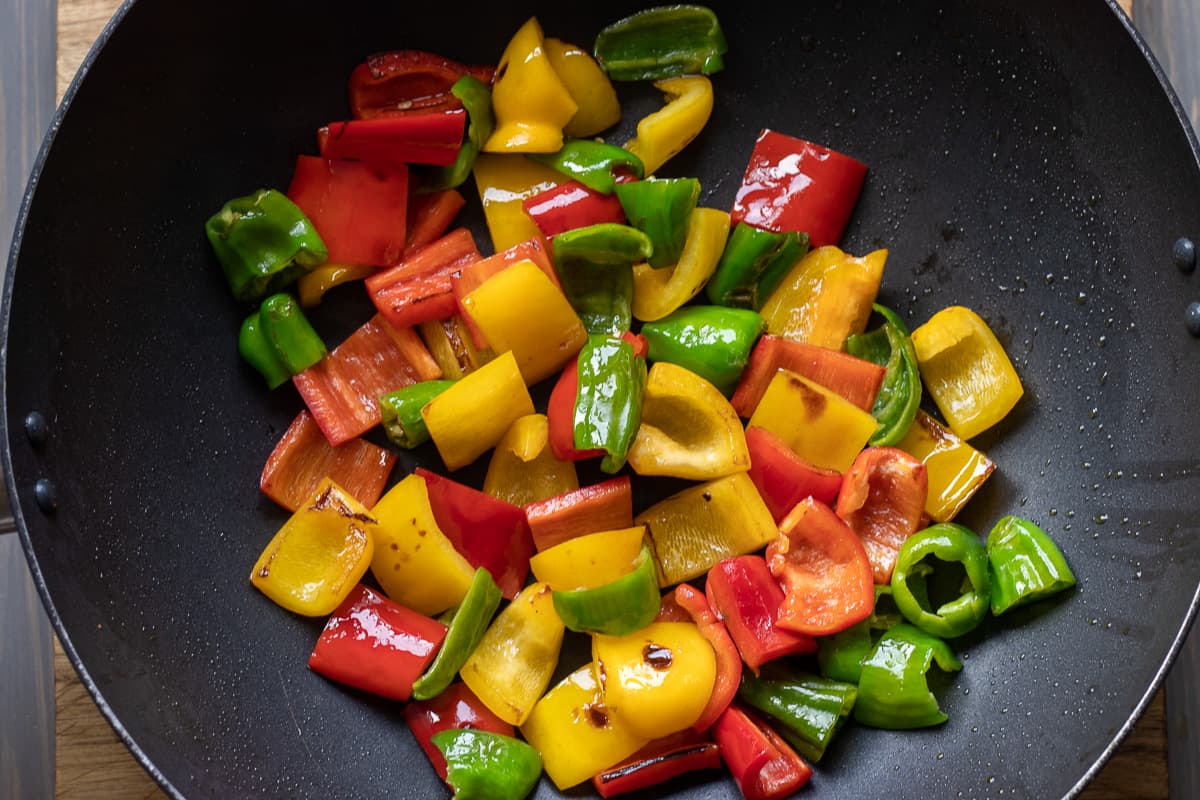 Sautéing peppers in a large pan