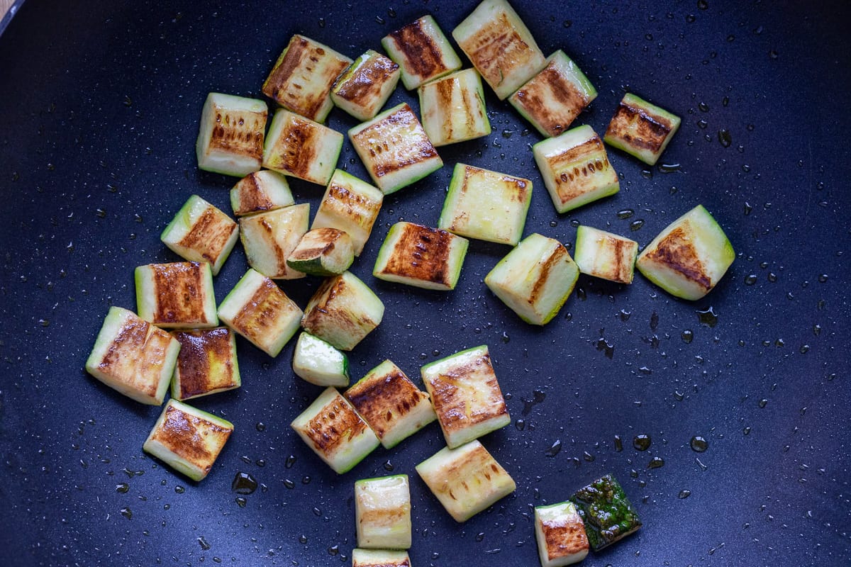 Sautéing the courgettes in a wok