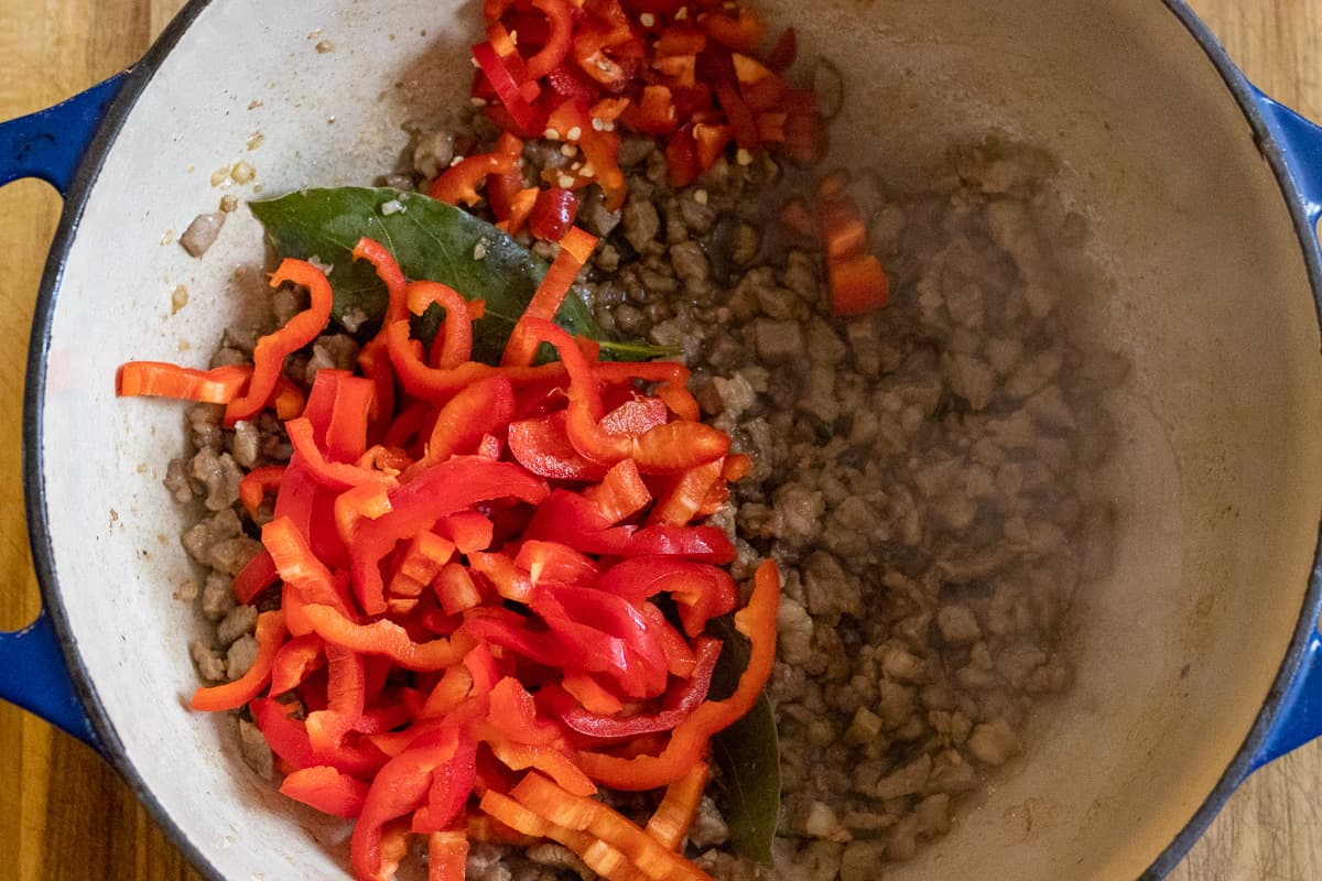 chilies and red peppers are added to the lamb