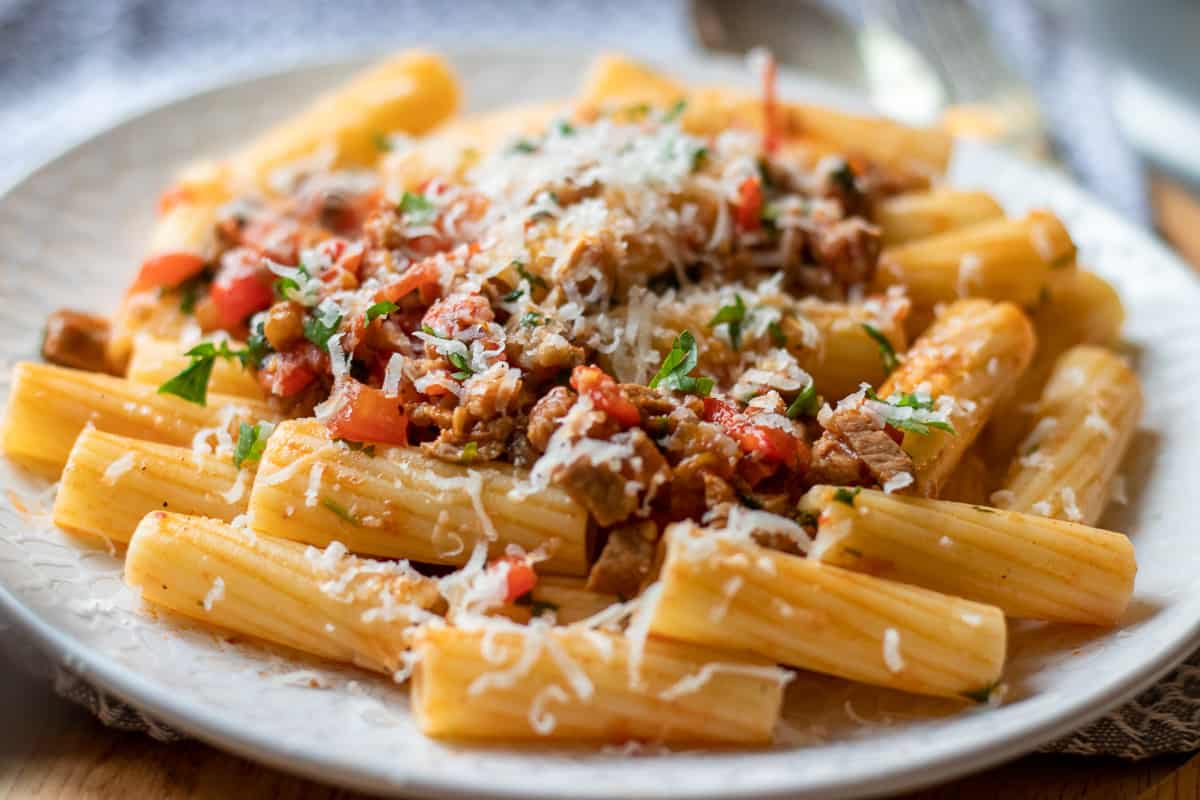 a bowl of slow cooked lamb ragu mixed with pasta