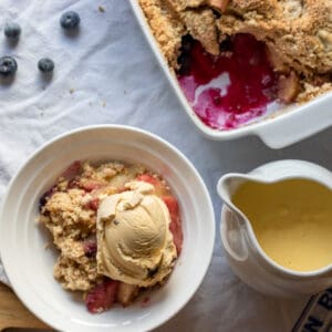 apple crumble served with custard and ice cream
