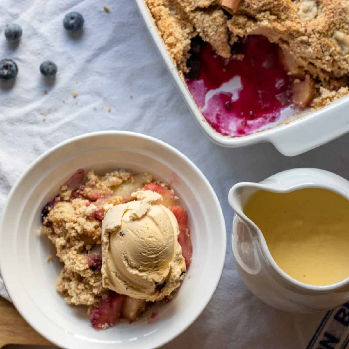 apple crumble served with custard and ice cream