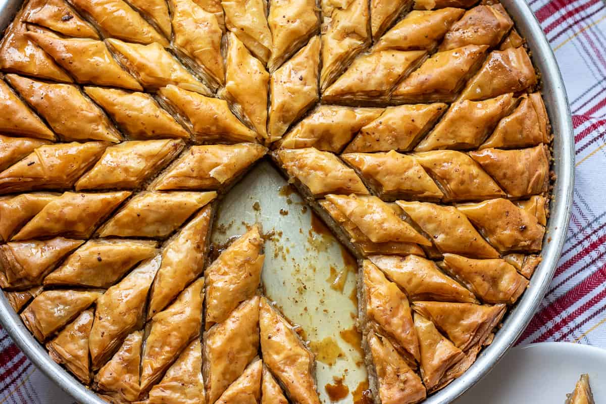 few pieces of authentic Middle Eastern walnut baklawa are removed from tray