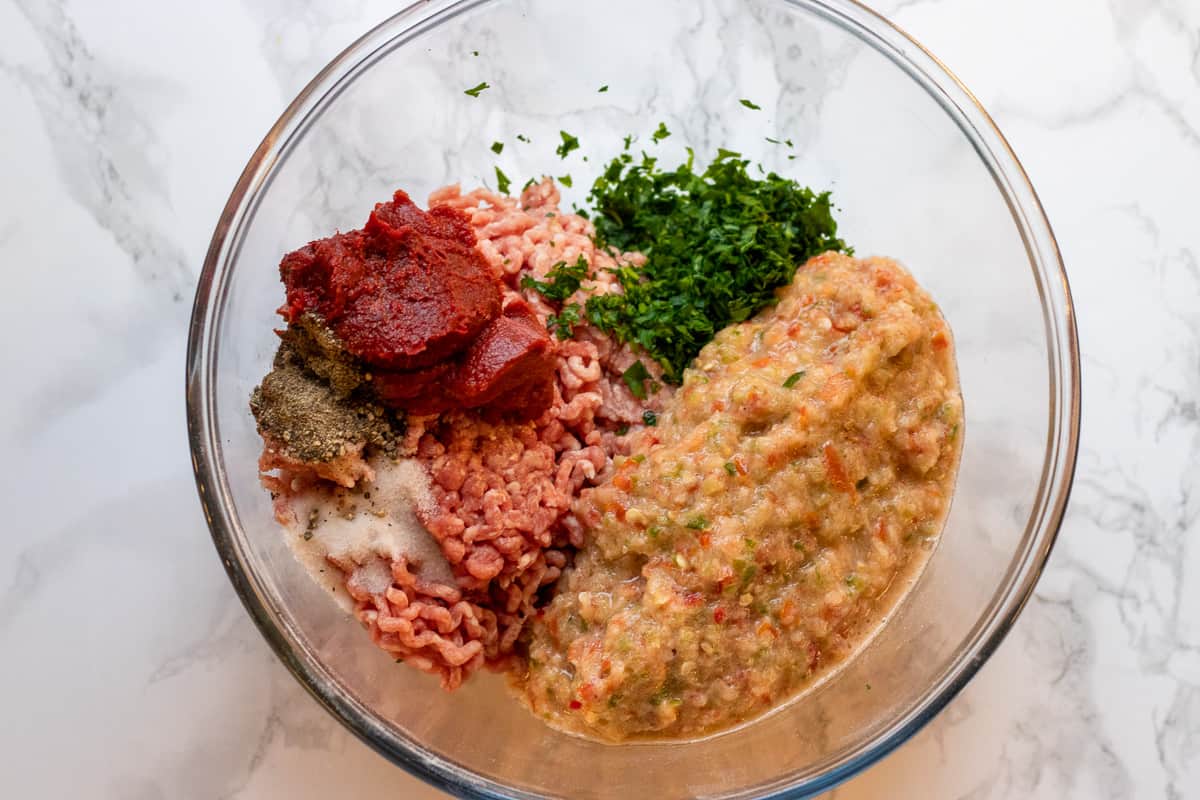 blitzed vegetables, mince, chopped parsley and tomato paste in a bowl