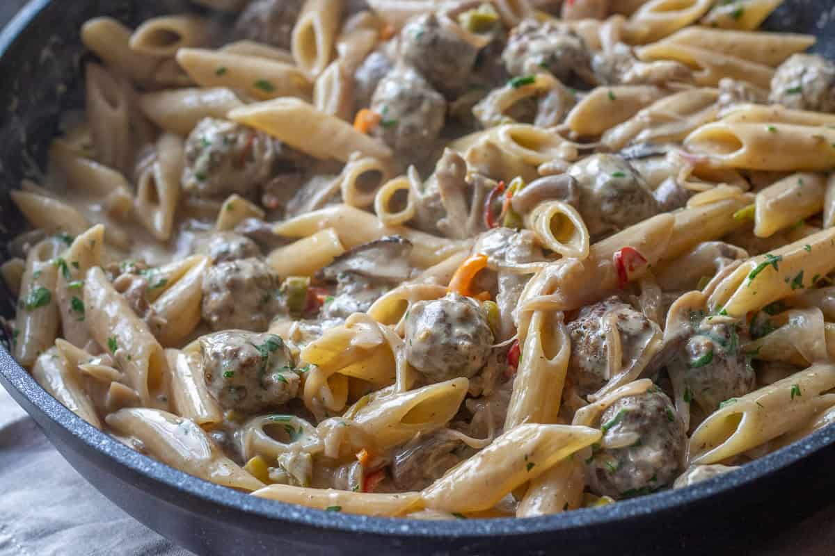 boiled pasta is added to creamy meatball sauce