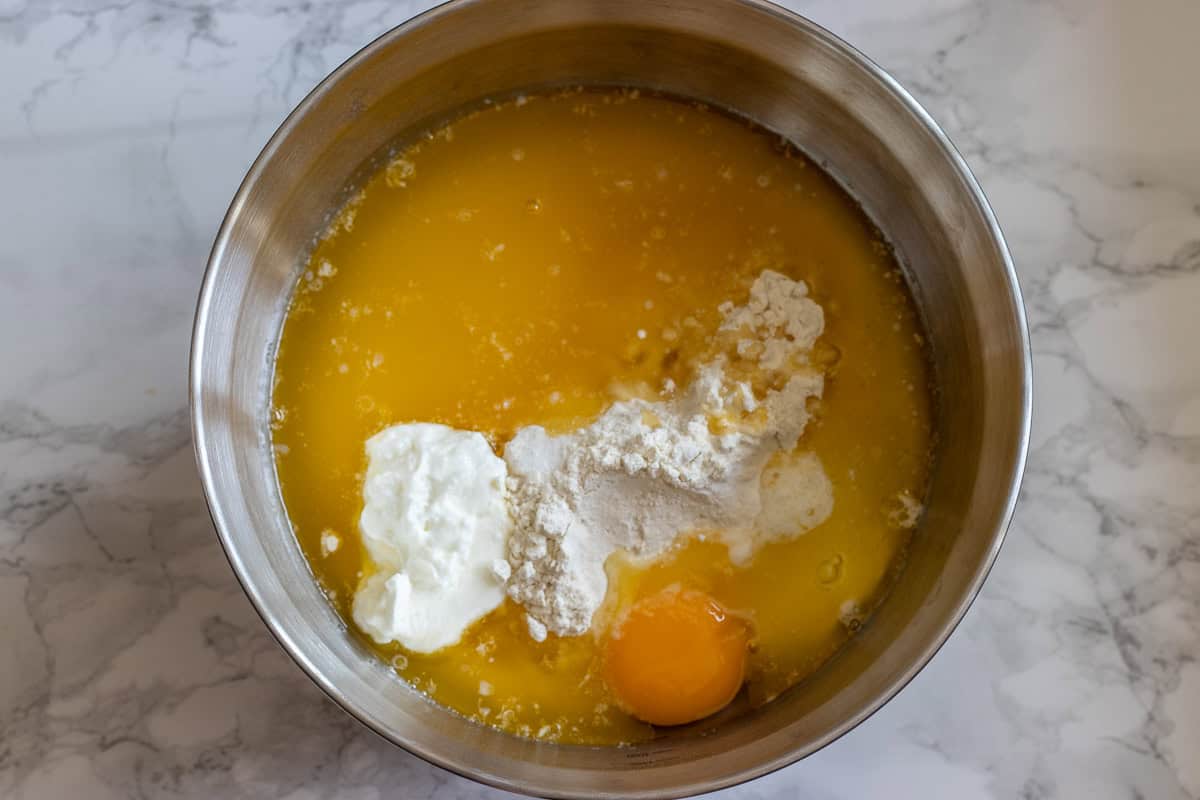 melted butter, egg, yogurt, sugar, and flour are placed in a bowl