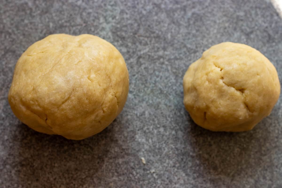 the pie dough is divided in two pieces