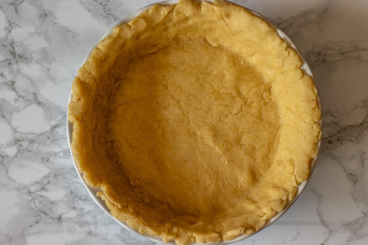 rolled put pie pastry is placed in a pie dish
