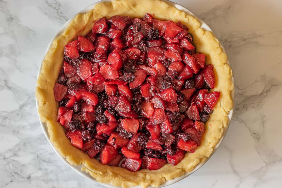 apple pie filling is placed in pastry case lined dish
