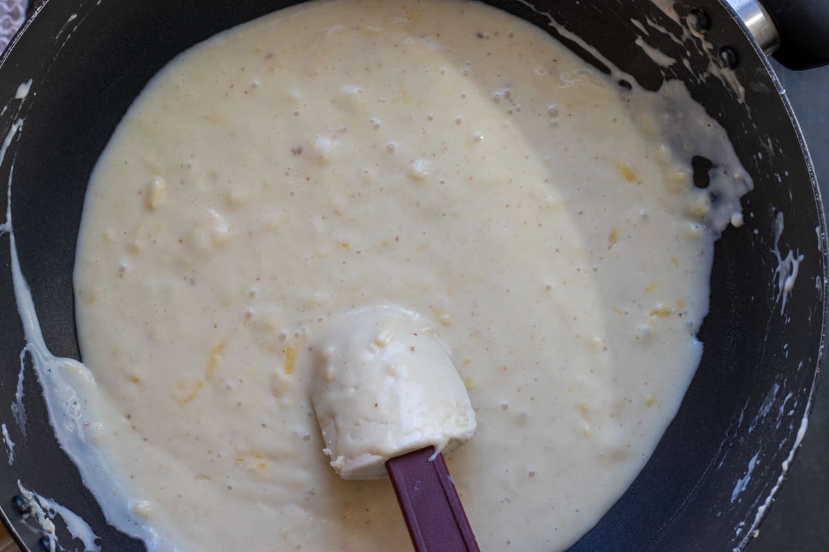 grated cheddar is added to the sauce