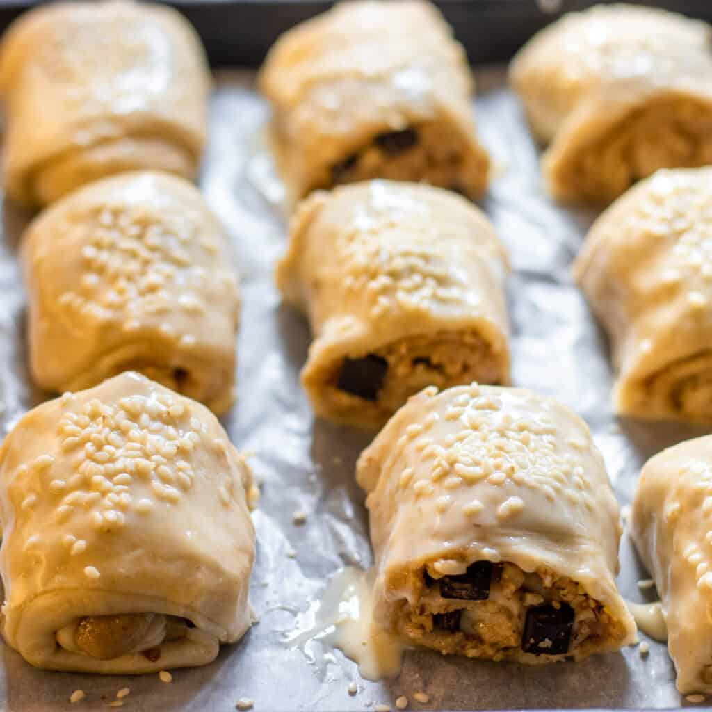 Brush the pastries with eggs and sprinkle sesame seeds on