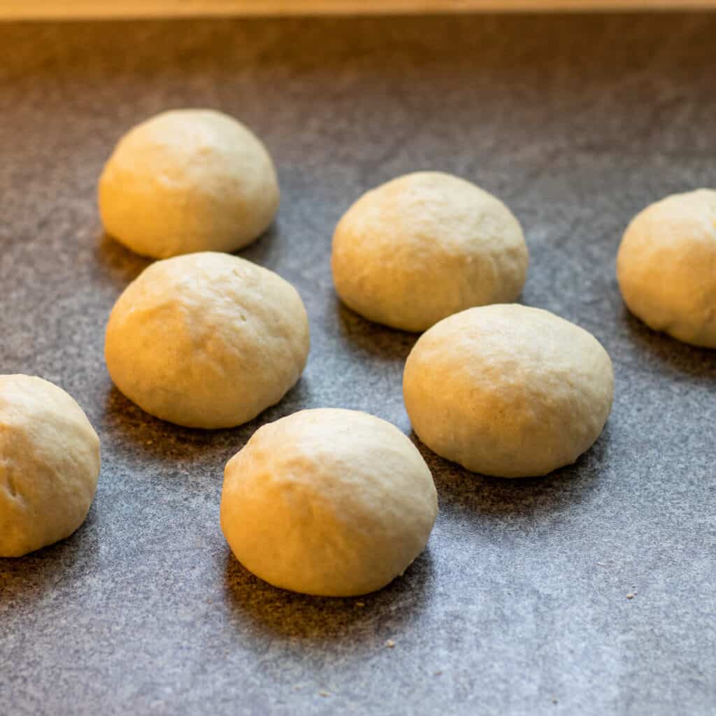 Dough for chocolate pastry rolls is divided in 8 equal balls.