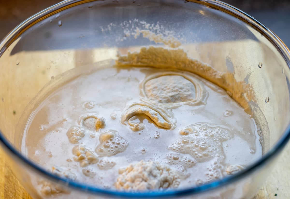 Add water, salt, flour and olive oil in a bowl for the dough for Sucuklu Pide (Turkish Bread with Spicy Sausage)