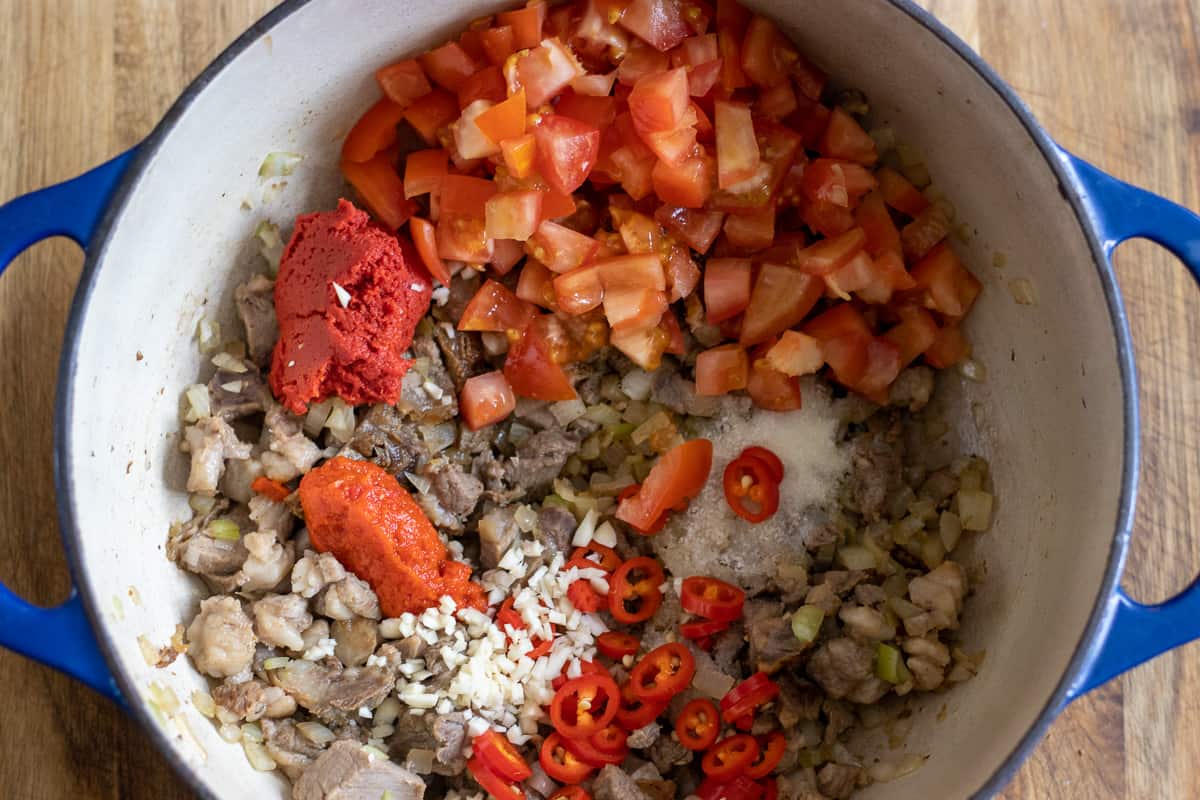 tomato&red pepper paste, tomatoes and chili are added to the pan