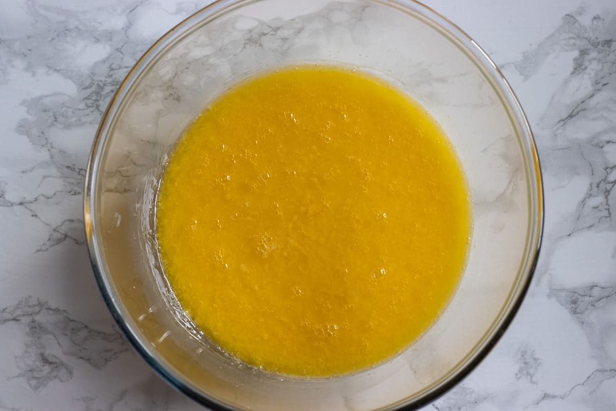 milk, eggs and melted butter are mixed in a bowl