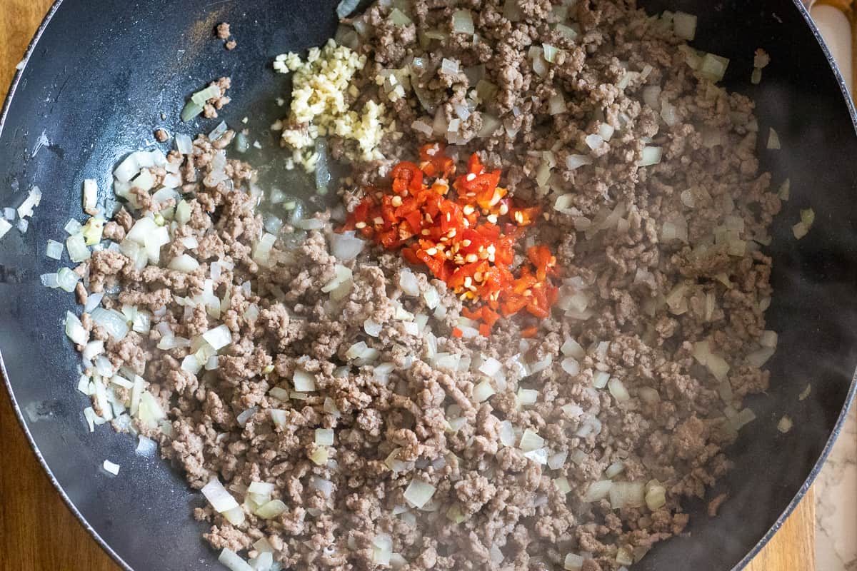 chili and garlic are added to sautéed beef and onions