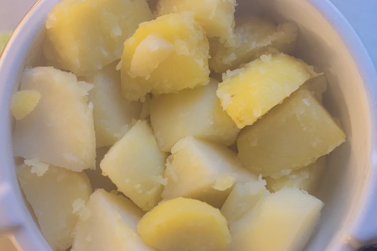 Potatoes are drained and placed on a colander