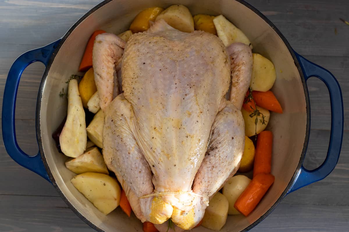 the chicken is seasoned with salt, pepper and olive oil and placed on top of the vegetables