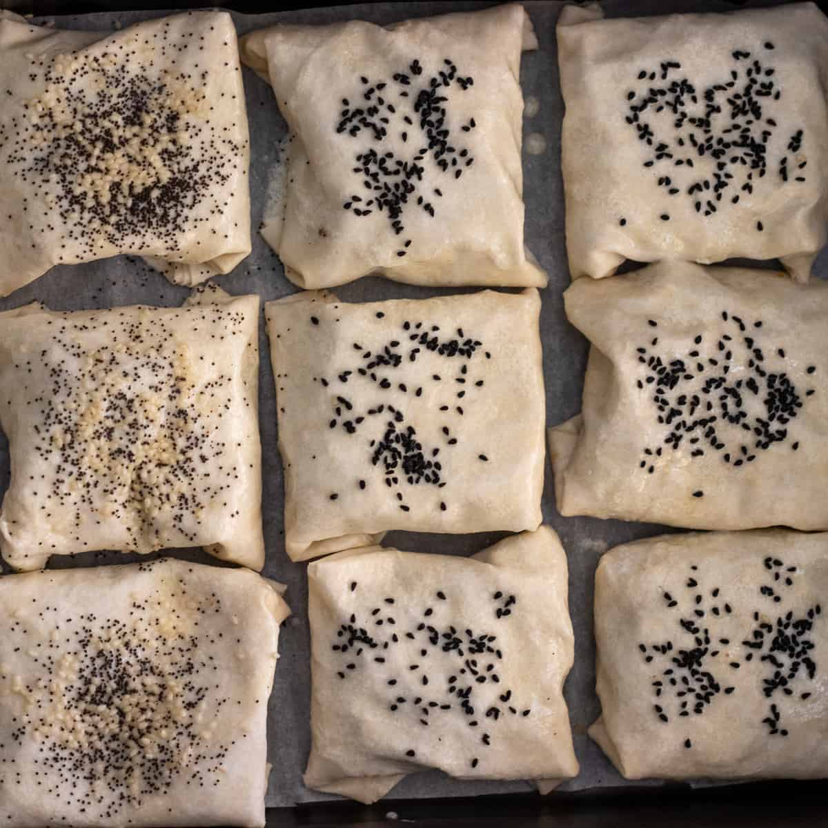 nigella seeds are sprinkled on top of the borek parcels