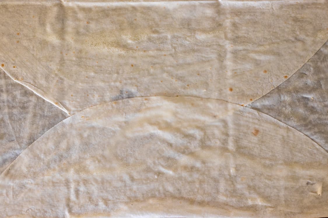 two opposite sides of the yufka are folded