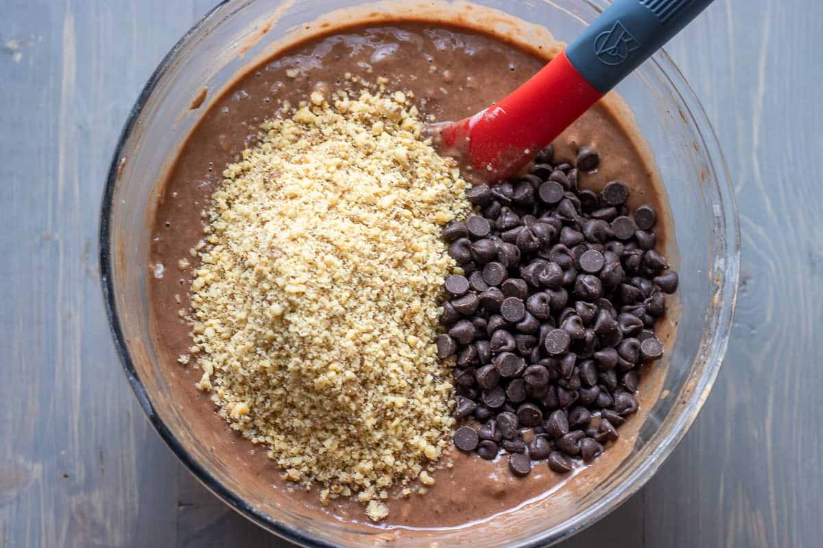Crashed nuts and chocolate chips are added to muffin batter.