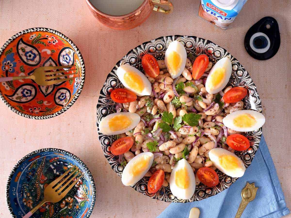 Piyaz is garnished with boiled eggs, and being served in small individual bowls.