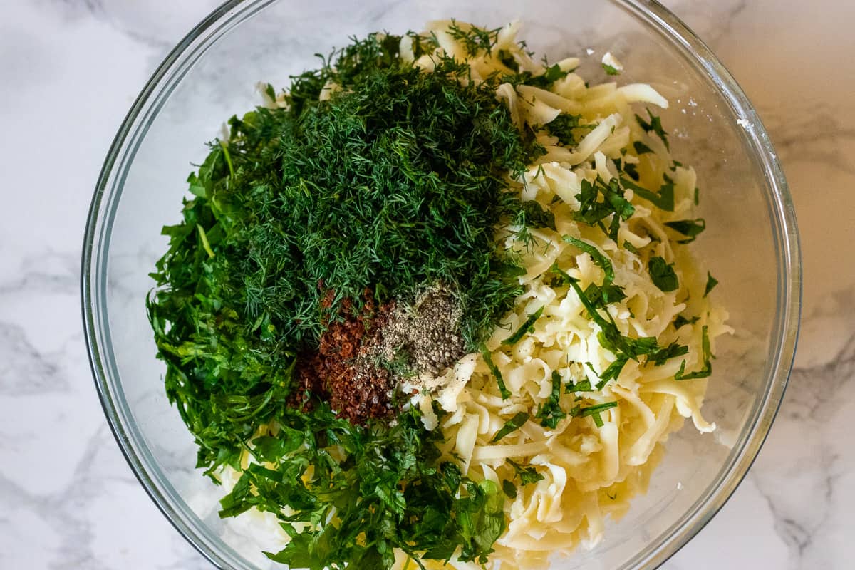 herbs ans spices are added to the bowl