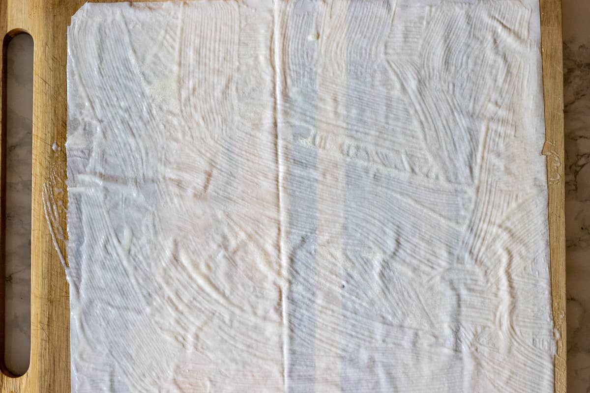 a filo sheet is brushed with sauce