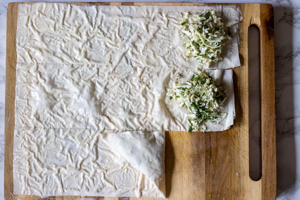 folding the pastry to cover the cheese filling entirely