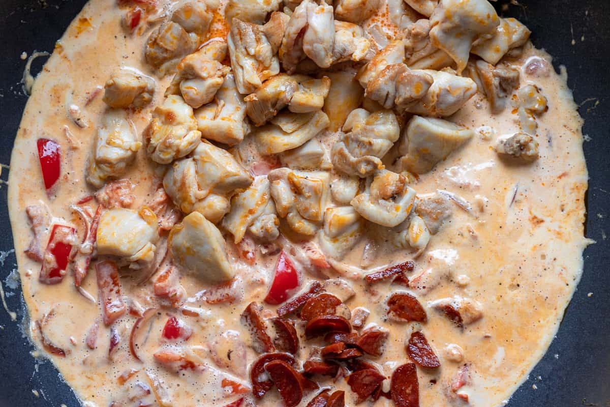 the chicken and chorizo are added to the pan