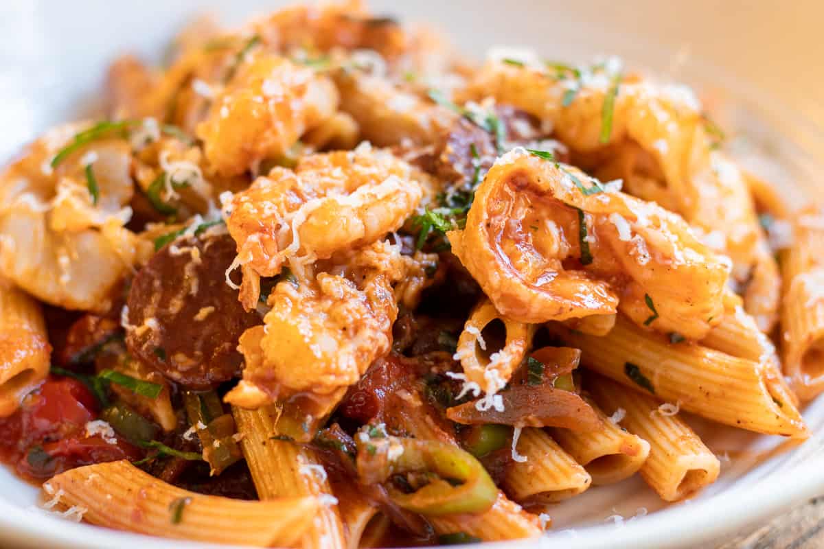 chorizo and shrimp pasta served with chopped parsley and grated parmesan