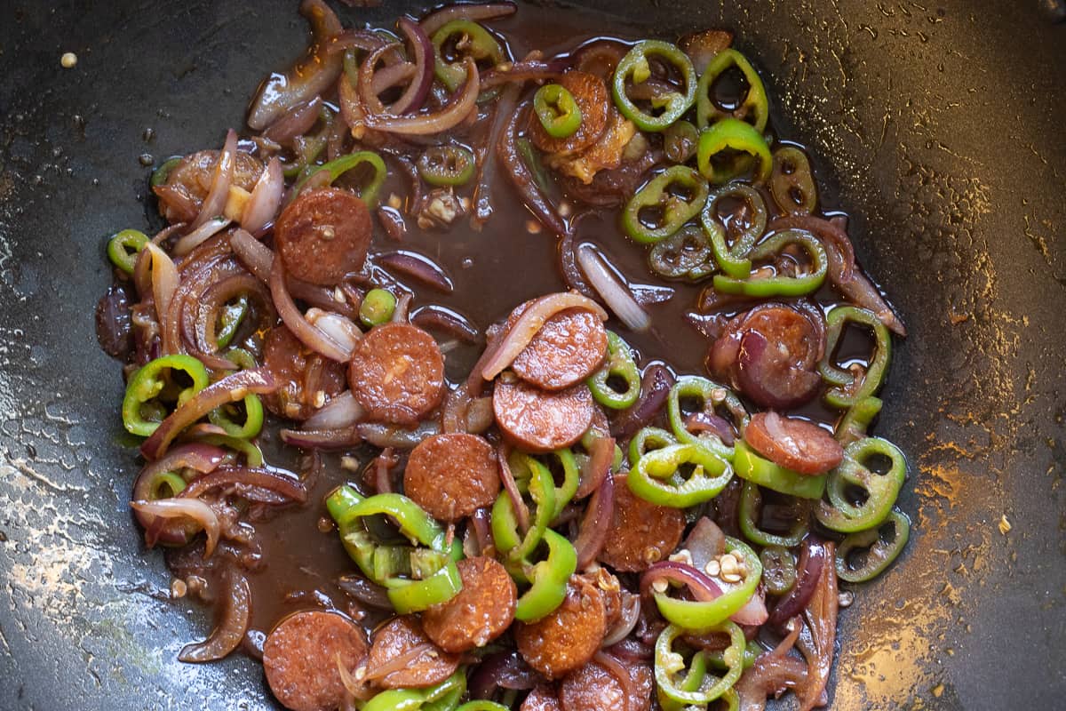 adding the red wine to the pan
