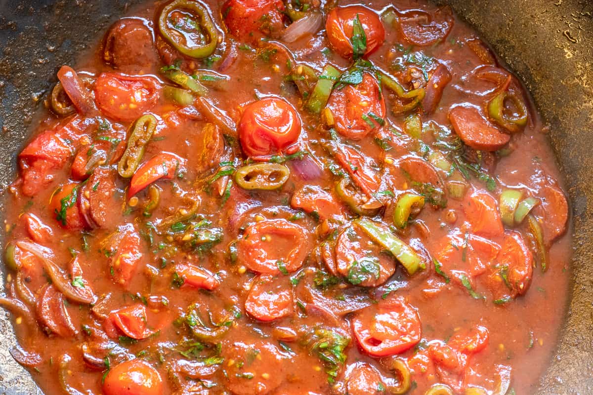 cooking the tomatoes for a minute with some pasta cooking water