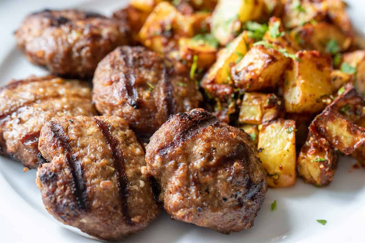 grilled lamb kofte served with batata harra 