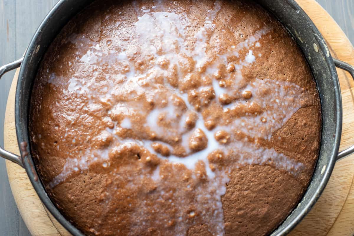 The milk is poured over the baked cake