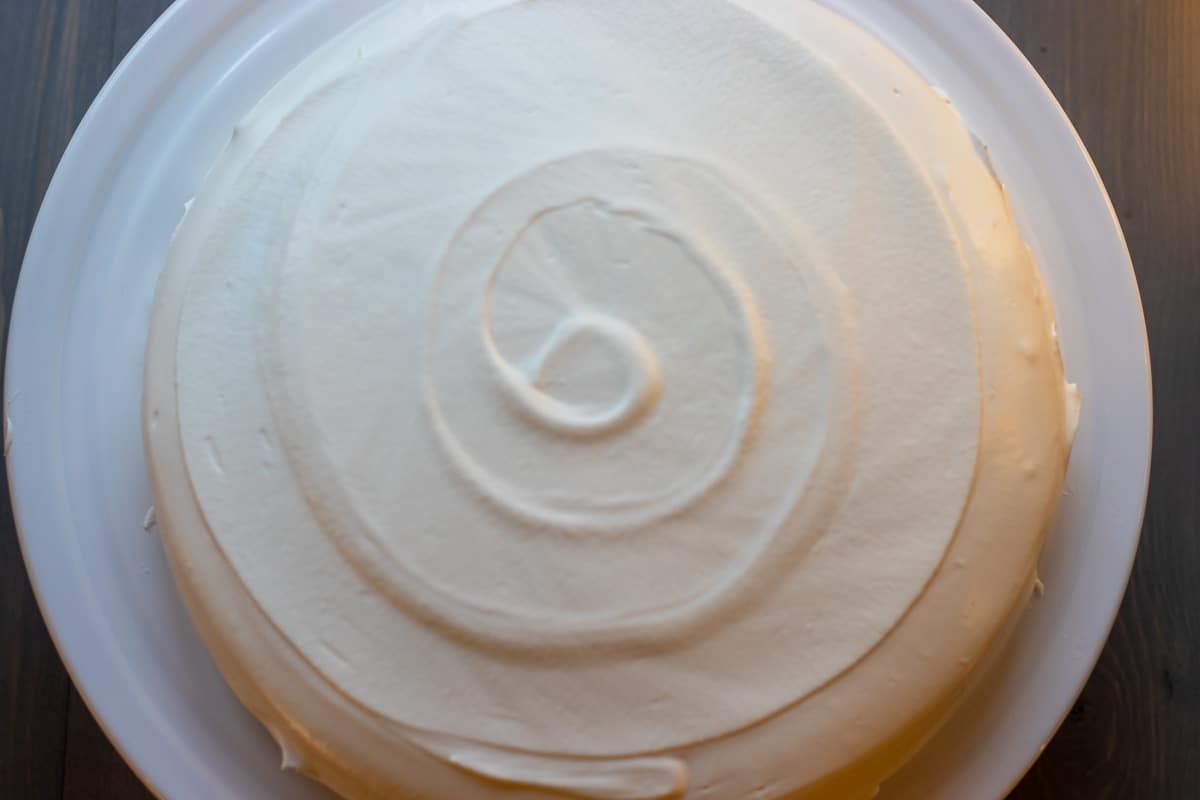 the creme Chantilly is spread over the cake