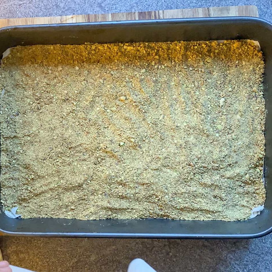 Pistachio nuts scattered over the layered filo sheets