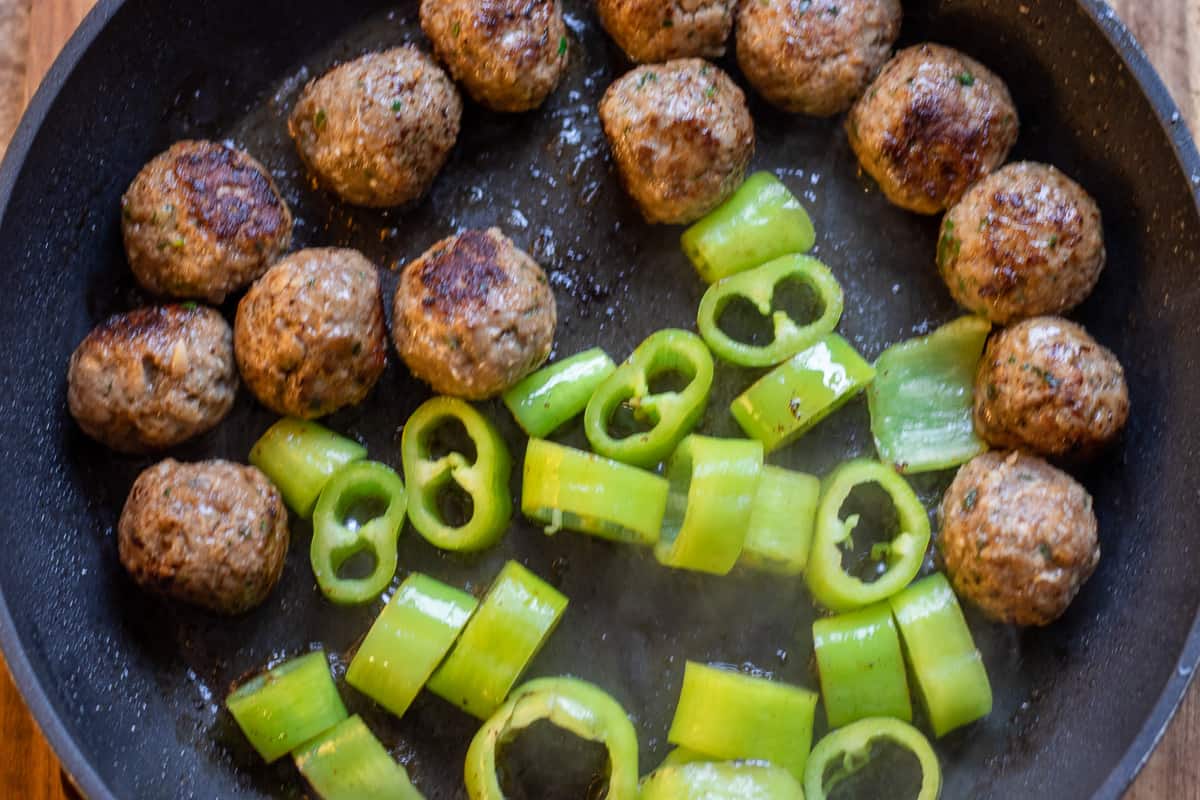 Sautéing the peppers in the same pan