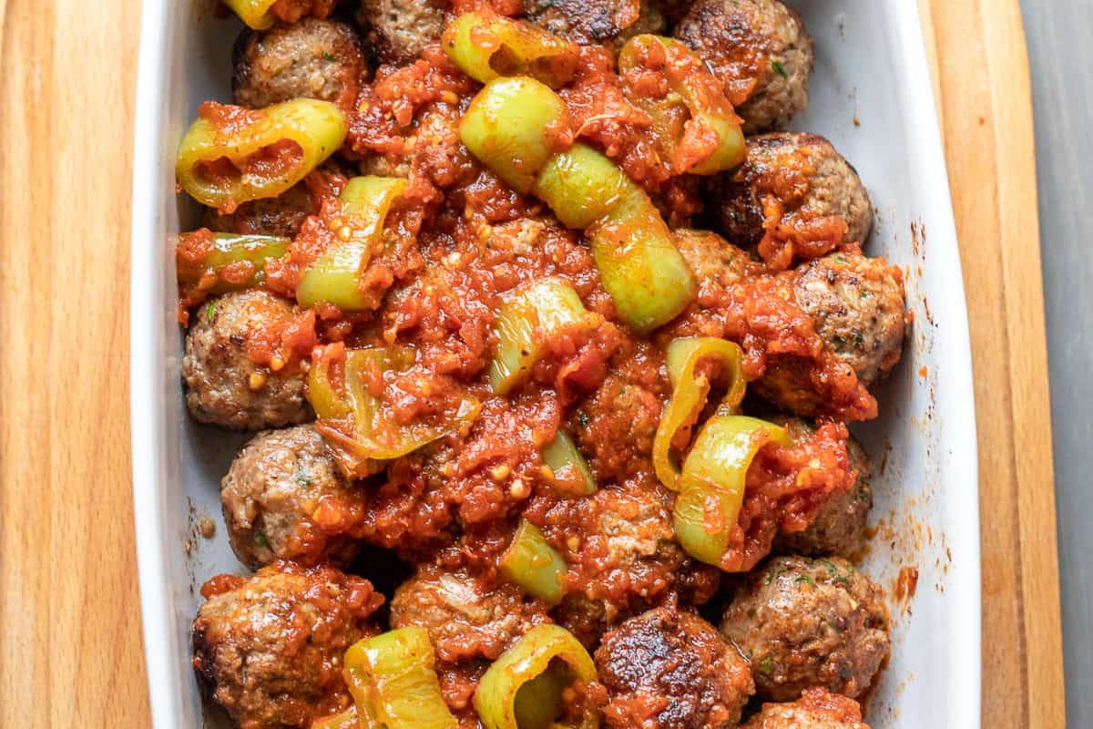 the sauce is poured on meatballs