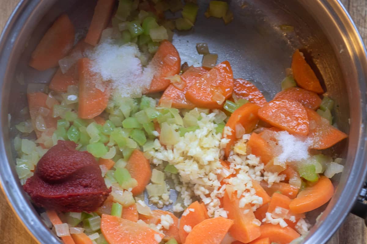 garlic, tomato paste, salt, sugar are added to the pan